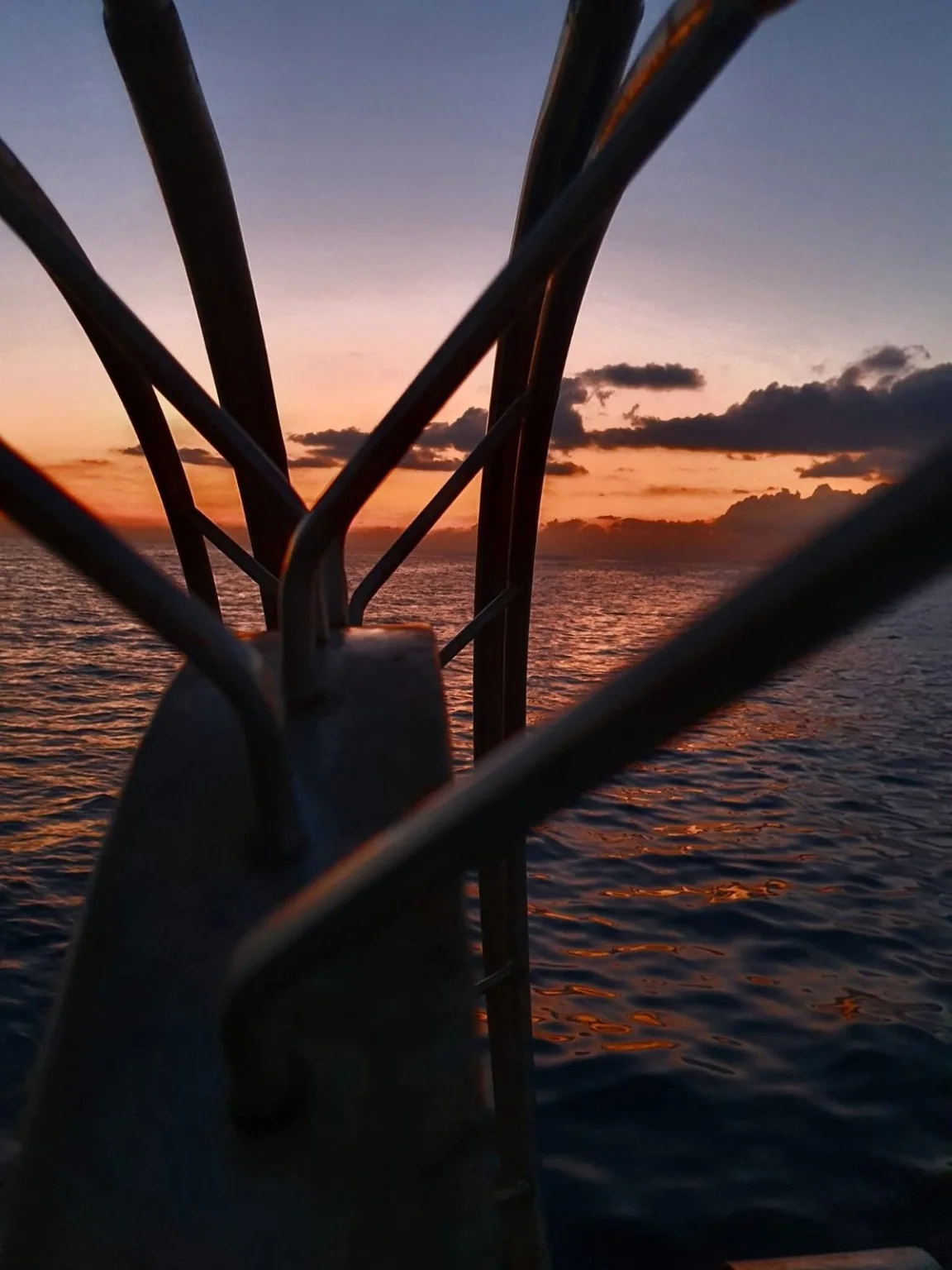 Sunset at sea viewed through Theoni's fishing equipment