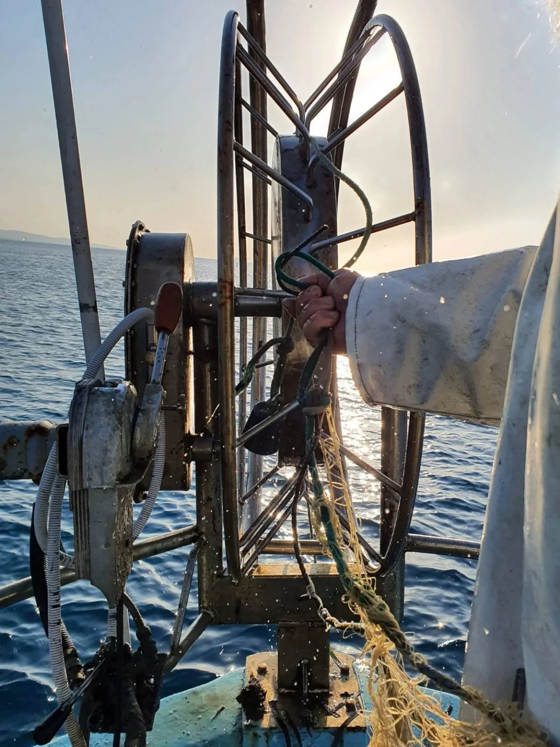 Traditional fishing net equipment in use aboard Theoni